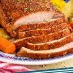 pinterest graphic for pork loin roast. Text says "pork loin roast simplejoy.com" Image shows a sliced pork roast on a plate with carrots and potatoes