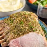 Pinterest photo of Roast Pork Loin with a front facing photo of a plate of pork loin. Says 'super easy roast pork loin simplejoy.com'