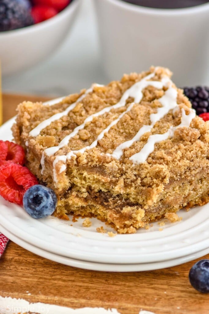 piece of coffee cake on a plate with fresh fruit