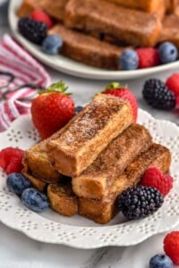 plate of french toast sticks with fresh berries