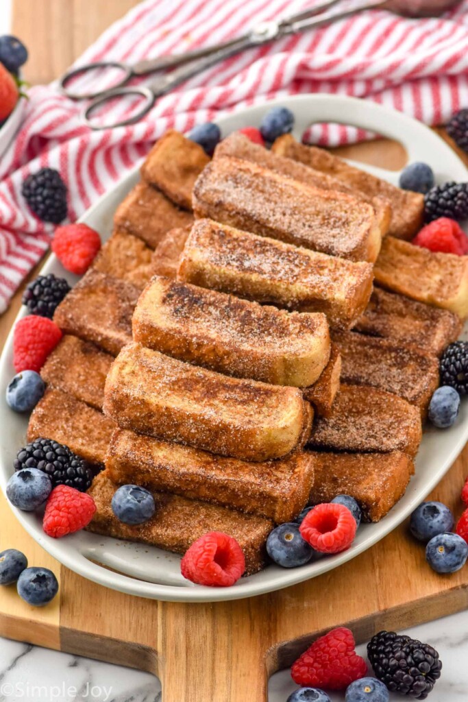 platter of french toast sticks for serving with fresh berries