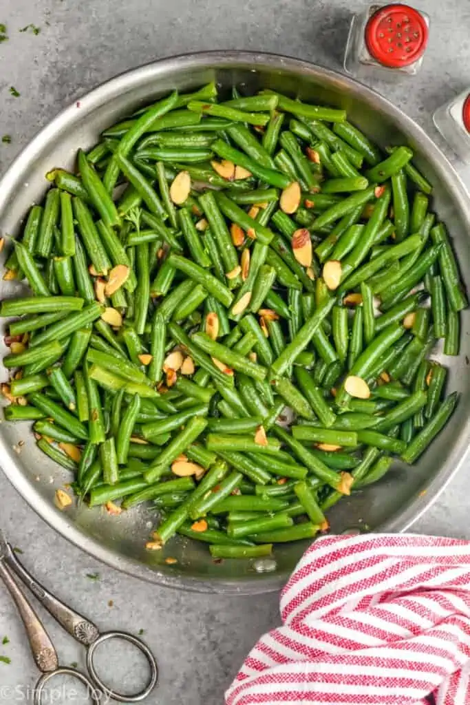 overhead photo of skillet with green bean almondine