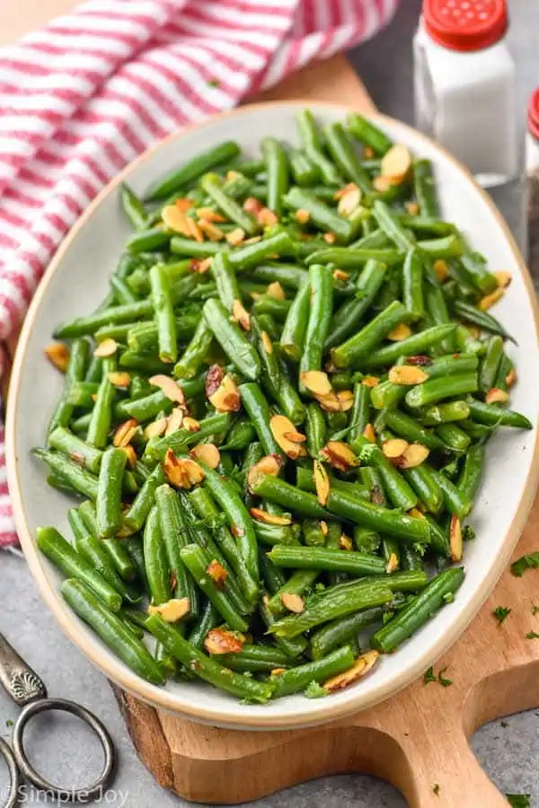 a serving platter of green beans almondine