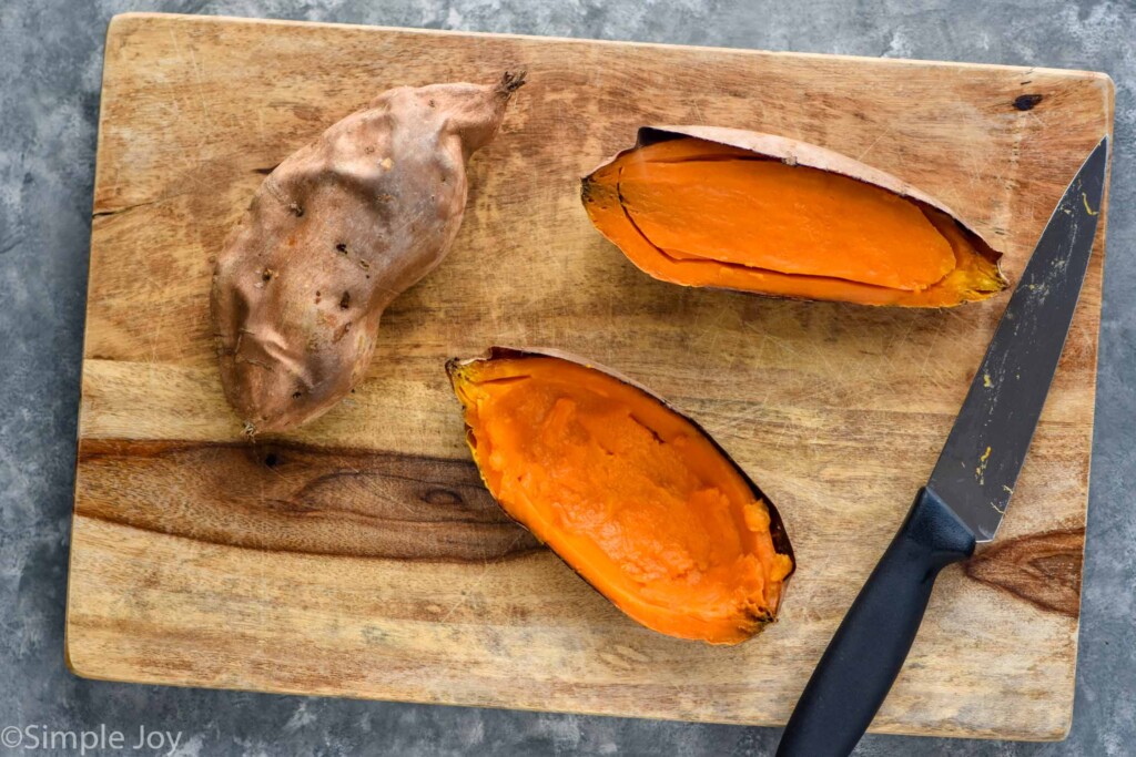 Overhead photo of sweet potatoes sliced on a cutting board for Twice Baked Sweet Potatoes recipe.