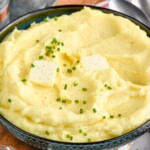 bowl of homemade mashed potatoes topped with butter and chives - 10