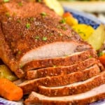 pork roast sliced with carrots and potatoes