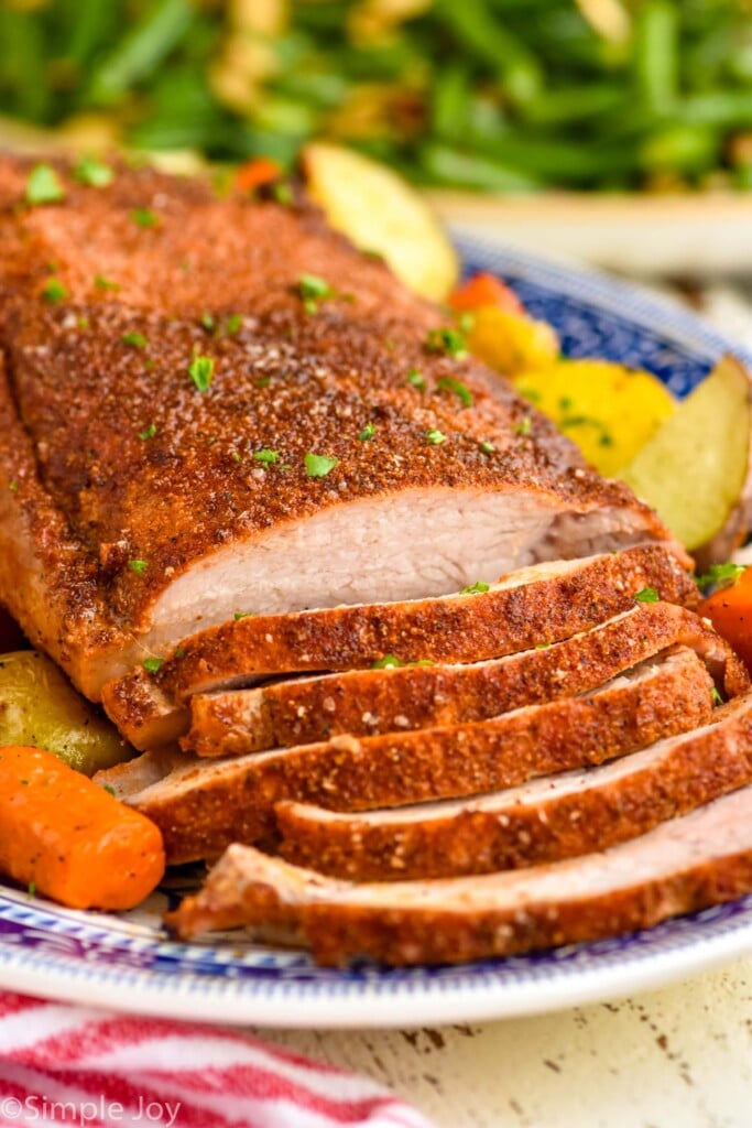 pork roast sliced with carrots and potatoes
