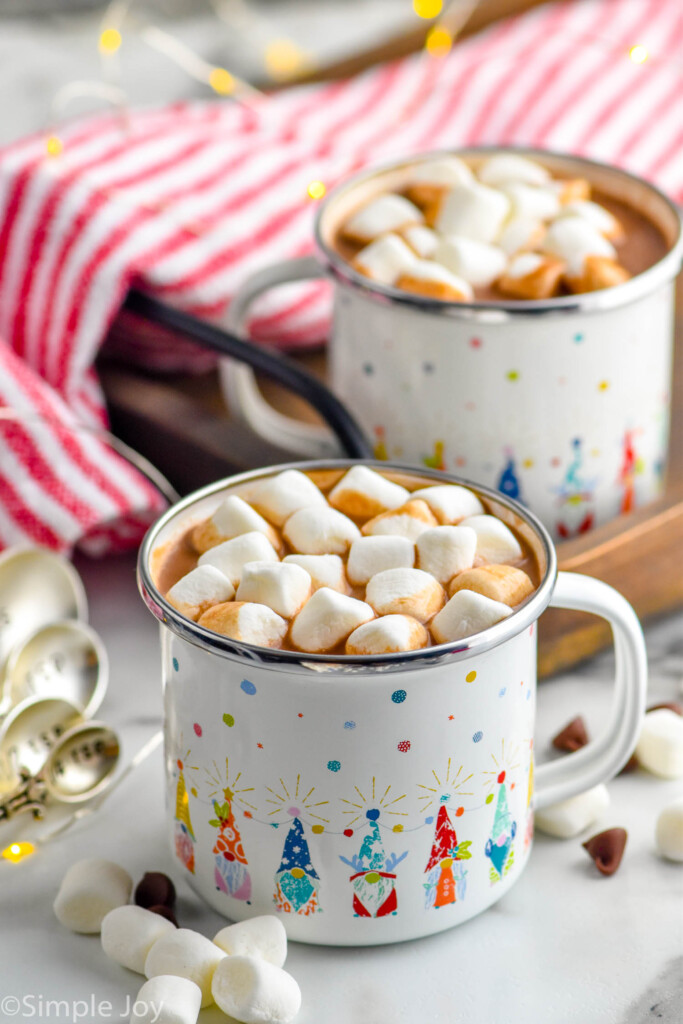Photo of Crockpot Hot Chocolate in two festive mugs with mini marshmallows
