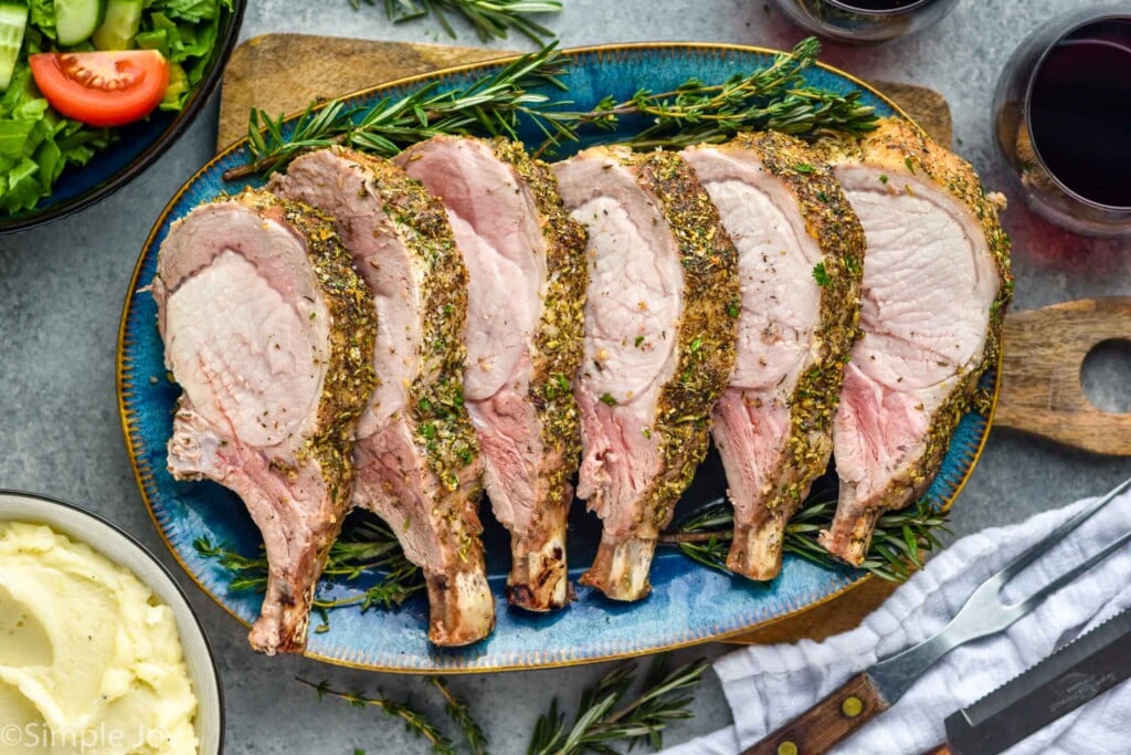 Horizontal overhead photo of roast pork loin on a blue plate