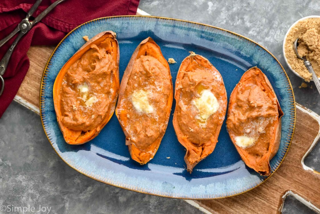 Overhead photo of Twice Baked Sweet Potatoes garnished with brown sugar and butter.