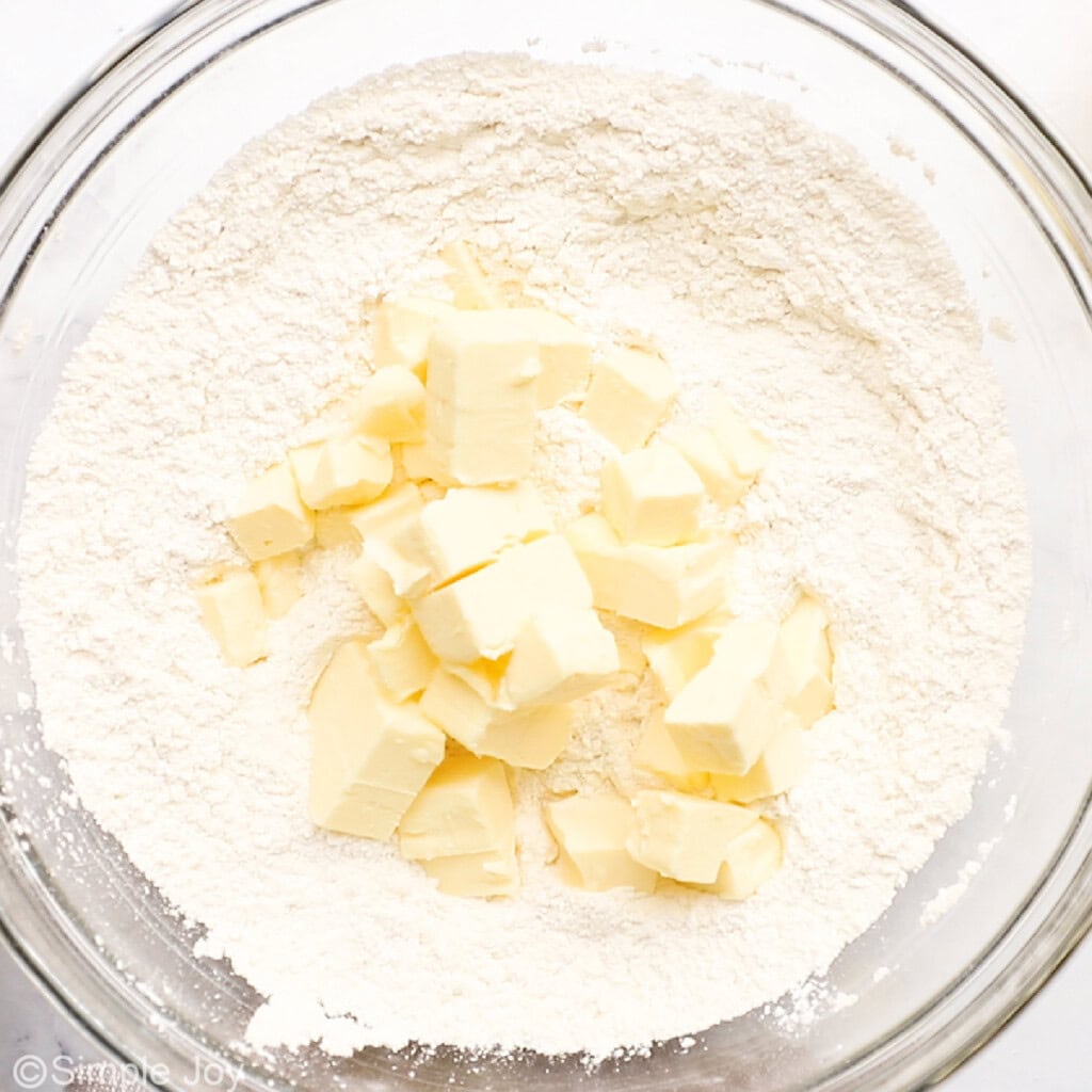 butter, flour, and powdered sugar in a bowl