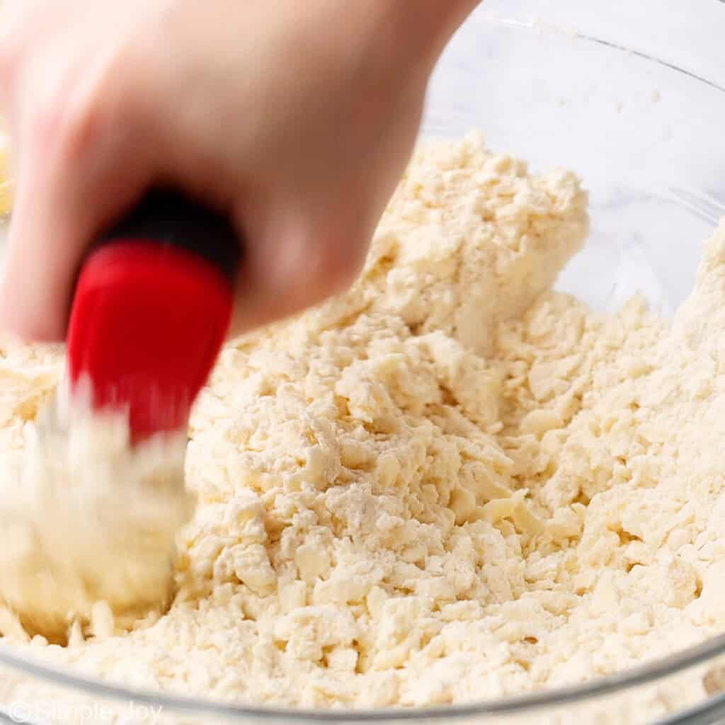 butter and flour being cut together with a pastry cutter