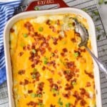Pinterest graphic for Twice Baked Potato Casserole. Text says, "The best Twice Baked Potato Casserole simplejoy.com." Image is overhead photo of a baking dish of Twice Baked Potato Casserole with a spoon for serving.