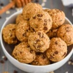 In a white bowl, the Five Ingredient No Bake Energy Bites are shaped into little balls and piled on top of each other. - 21