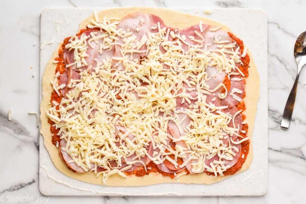 overhead of making a Stromboli after topping it with cheese 