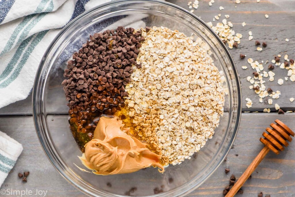 ingredients for no bake energy bites broken down by type in a bowl