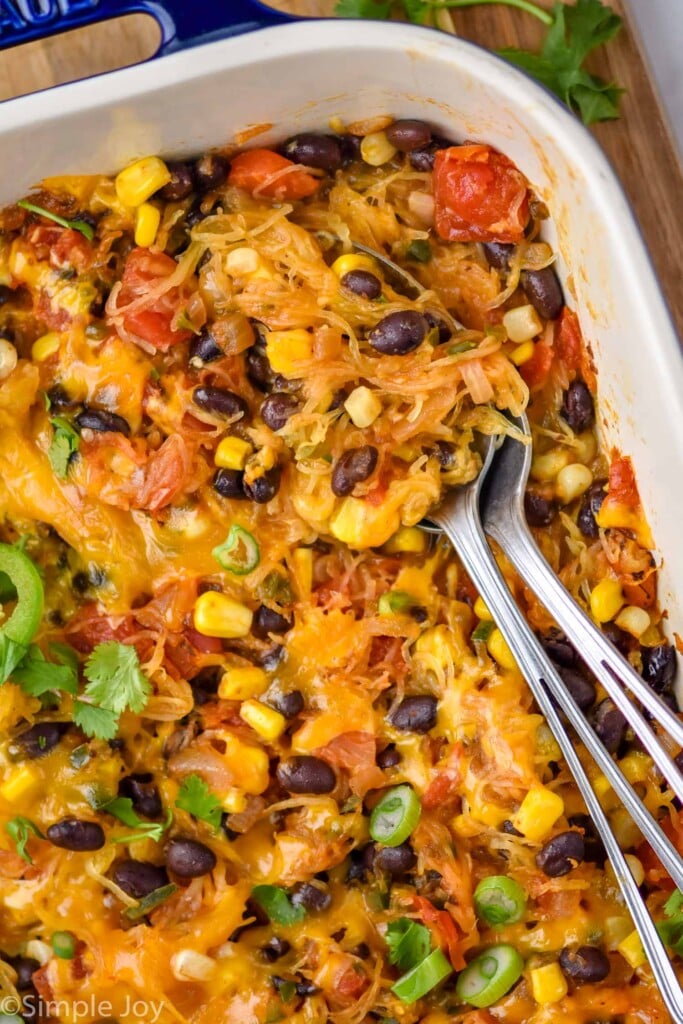 Overhead photo of a baking dish of Spaghetti Squash Casserole with spoons for serving