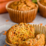 Close up photo of Carrot Cake Muffins. The front muffin is broken in half for eating.