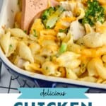 Pinterest graphic for Chicken Broccoli Noodle Casserole recipe. Image is close up photo of a baking dish of Chicken Broccoli Noodle Casserole with a spoon for serving. Text says, "Delicious Chicken Broccoli Noodle Casserole simplejoy.com"