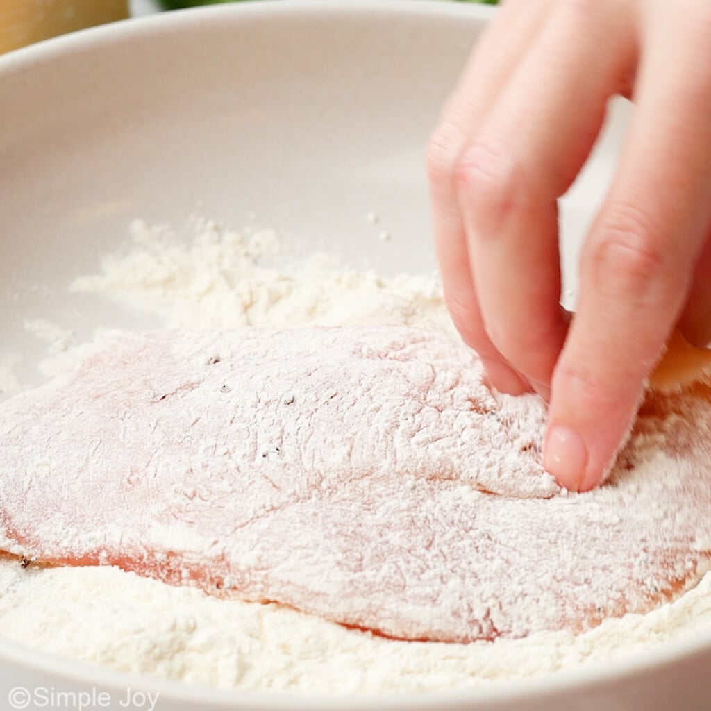 chicken bein dredged in flour