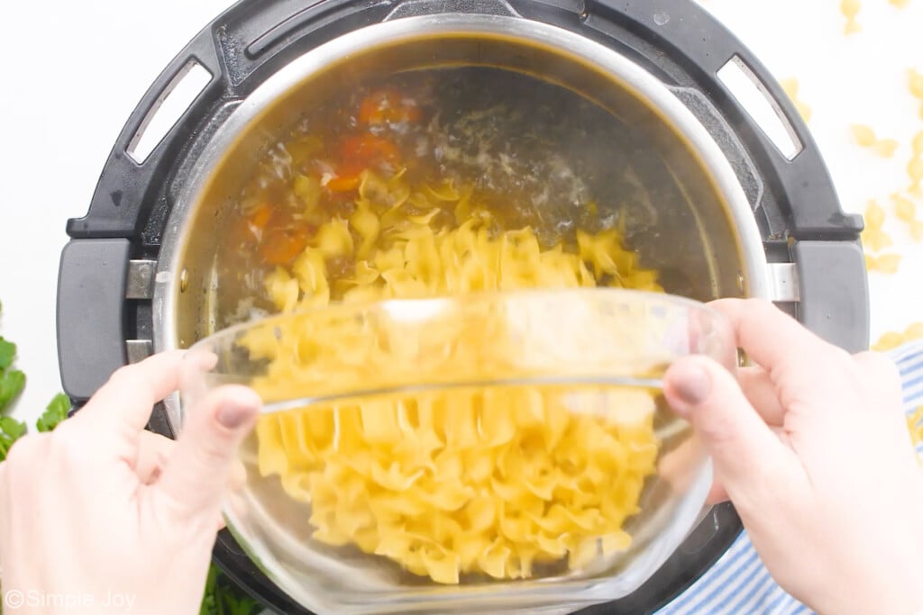 adding noodles to the instant pot to make instant pot chicken noodle soup - 9