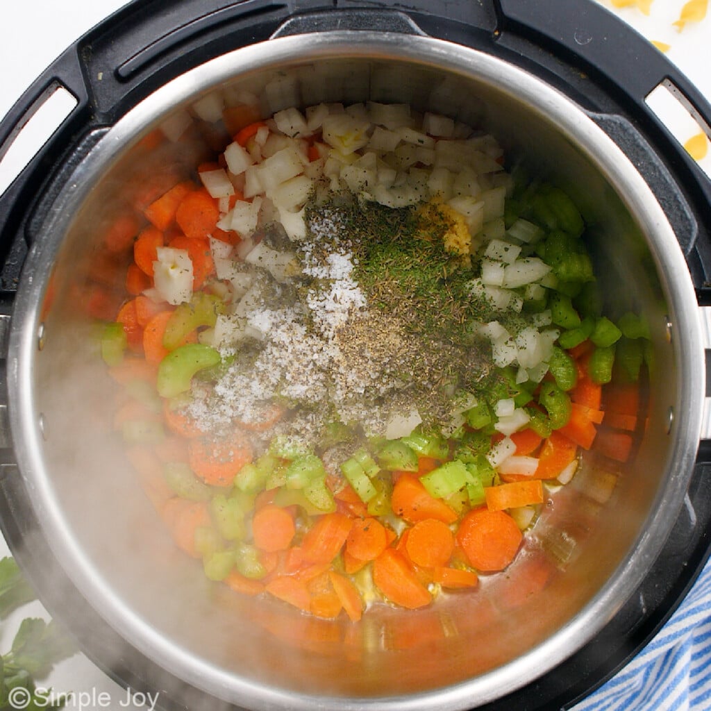 overhead of an instant pot with vegetables and seasonings