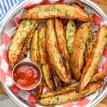 Overhead photo of Air Fryer Potato Wedges served with ketchup for dipping. - 10