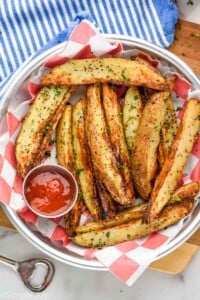 Overhead photo of Air Fryer Potato Wedges served with ketchup for dipping.