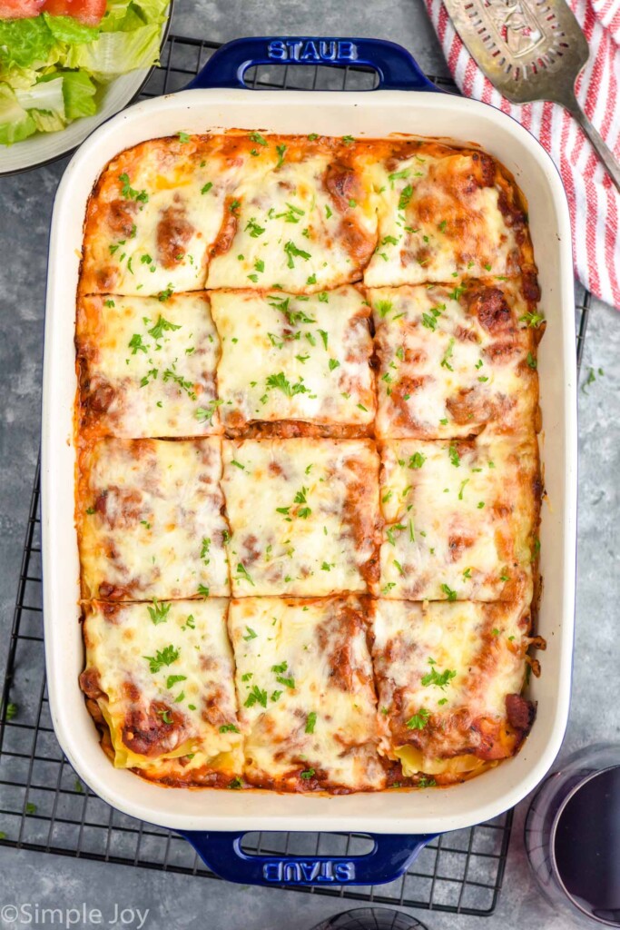 Overhead photo of a baking dish of Homemade Lasagna cut into squares for serving.