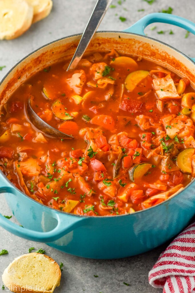 Overhead photo of a pot of Vegetable Soup with a ladle for serving.