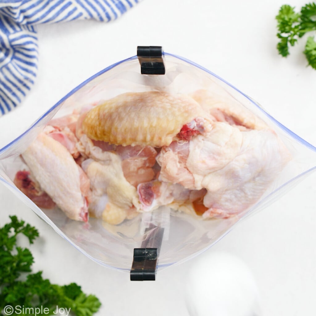 overhead of chicken wings in a ziplock bag
