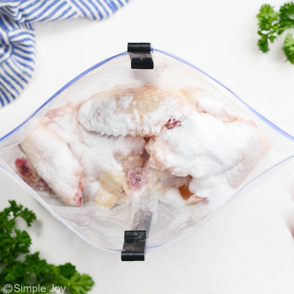 baking powder and salt coating chicken wings in a ziplock bag