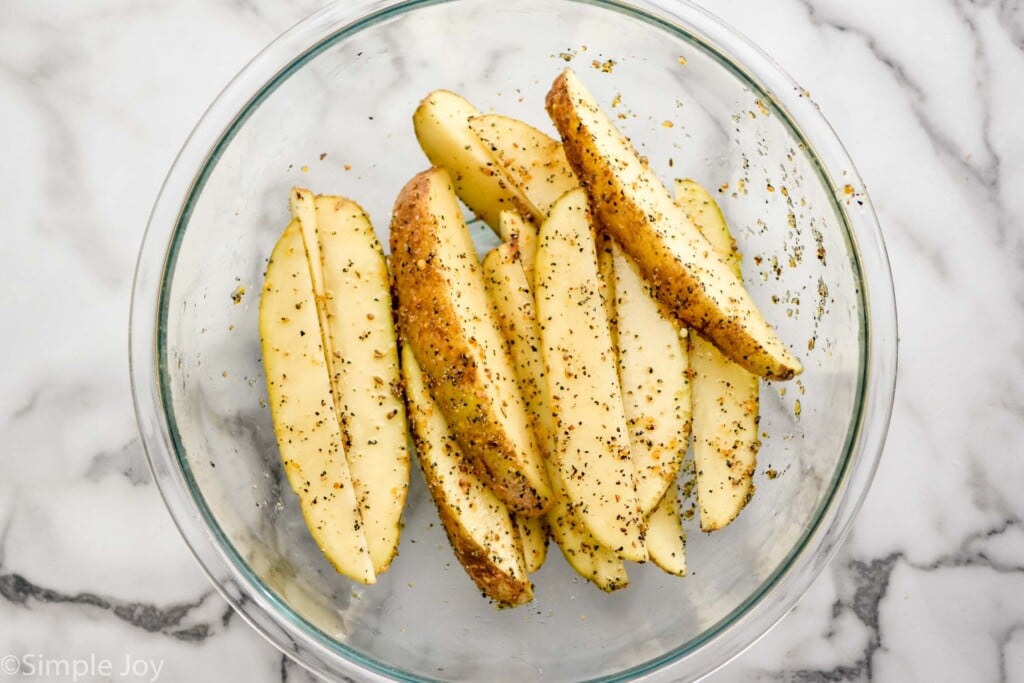 Overhead photo of Air Fryer Potato Wedges in a bowl before cooking.