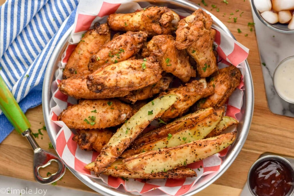 Overhead photo of Old Bay Chicken Wings served with air fryer potato wedges.