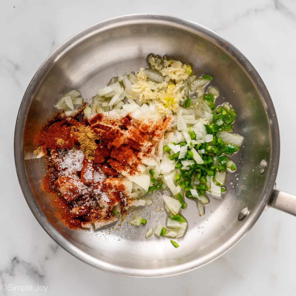onion, garlic, jalapeno, and seasonings raw in a skillet