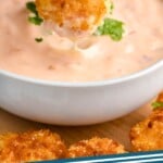 Pinterest graphic for Bang Bang Sauce recipe. Image is photo of person's hand dipping breaded shrimp into a bowl of Bang Bang Sauce. Text says, "Bang Bang Sauce simplejoy.com"