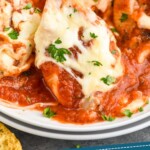 Pinterest graphic for Stuffed Shells recipe. Image is close up photo of a plate of Stuffed Shells. Text says, "amazing meat stuffed shells simplejoy.com"