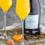 Pinterest graphic for Mimosa recipe. Image is close up photo of two mimosas and a bottle of champagne. Text says, "the best Mimosa simplejoy.com"