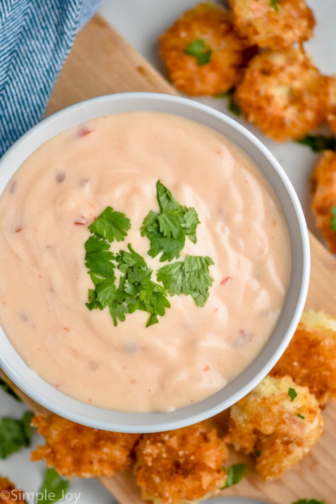 Overhead photo of a bowl of Bang Bang Sauce with breaded shrimp beside bowl.