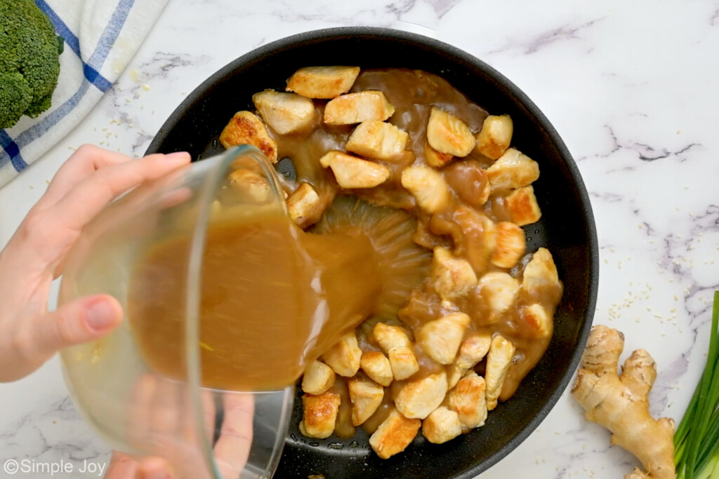 adding sauce to a skillet of sautéed chicken