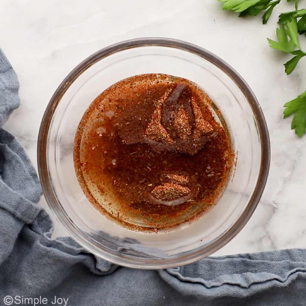 overhead of a bowl of cajun seasoning and oil