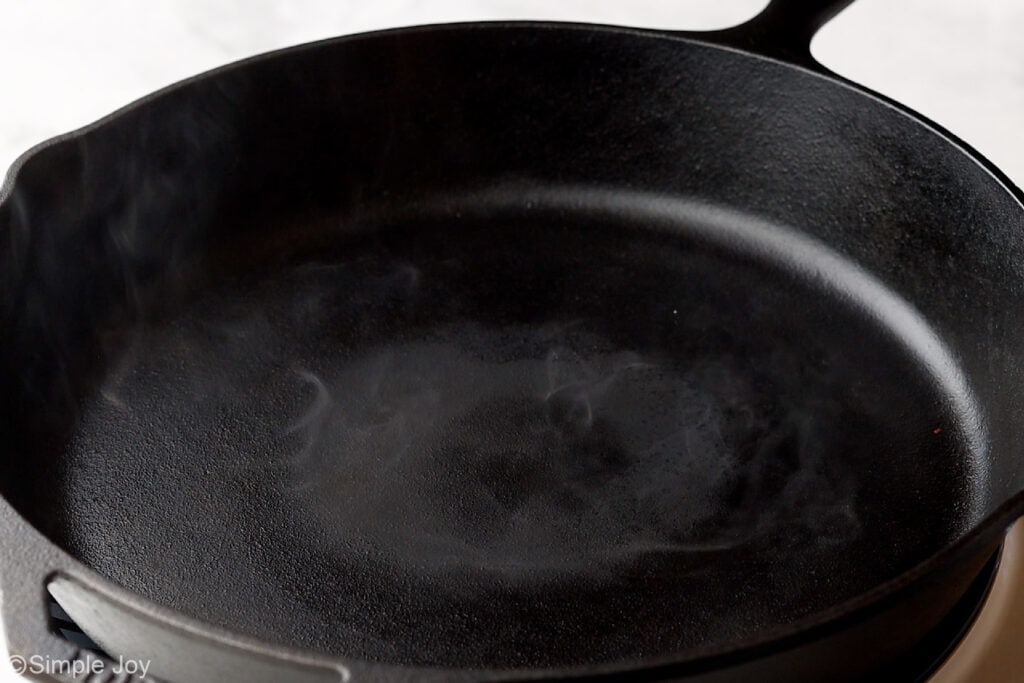 close up of a cast iron skillet that is smoking
