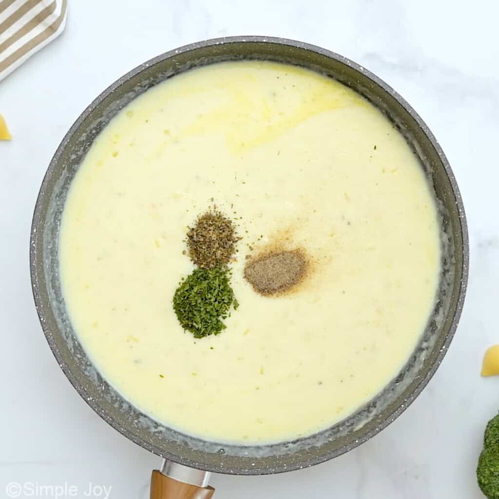 spices going into a cream sauce