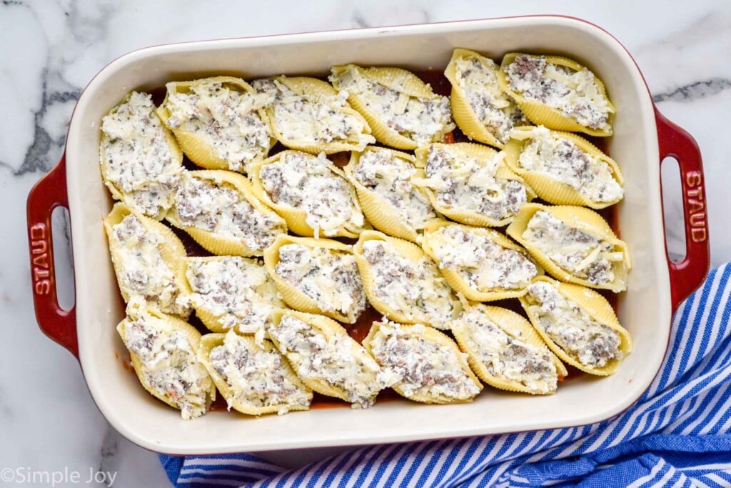 Overhead photo of a baking dish of ingredients for Stuffed Shells recipe.