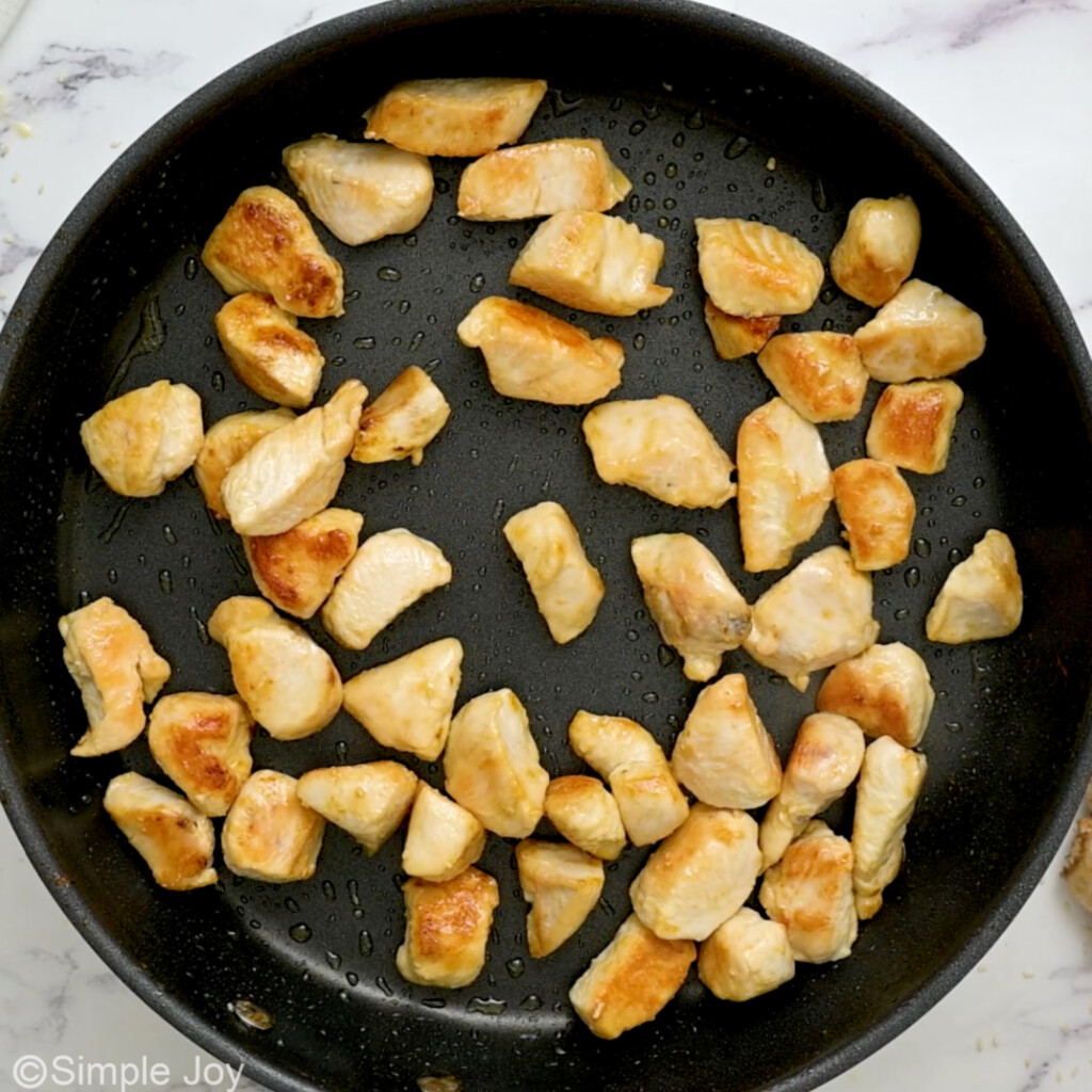 overhead of sauted chicken in a skillet