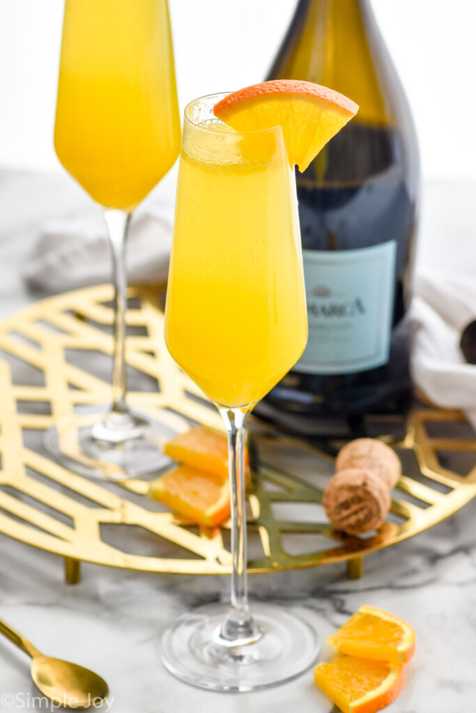Overhead photo of Mimosa cocktails and a bottle of champagne.