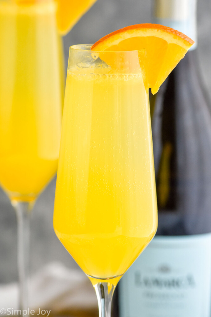 Close up photo of Mimosa garnished with orange slice.