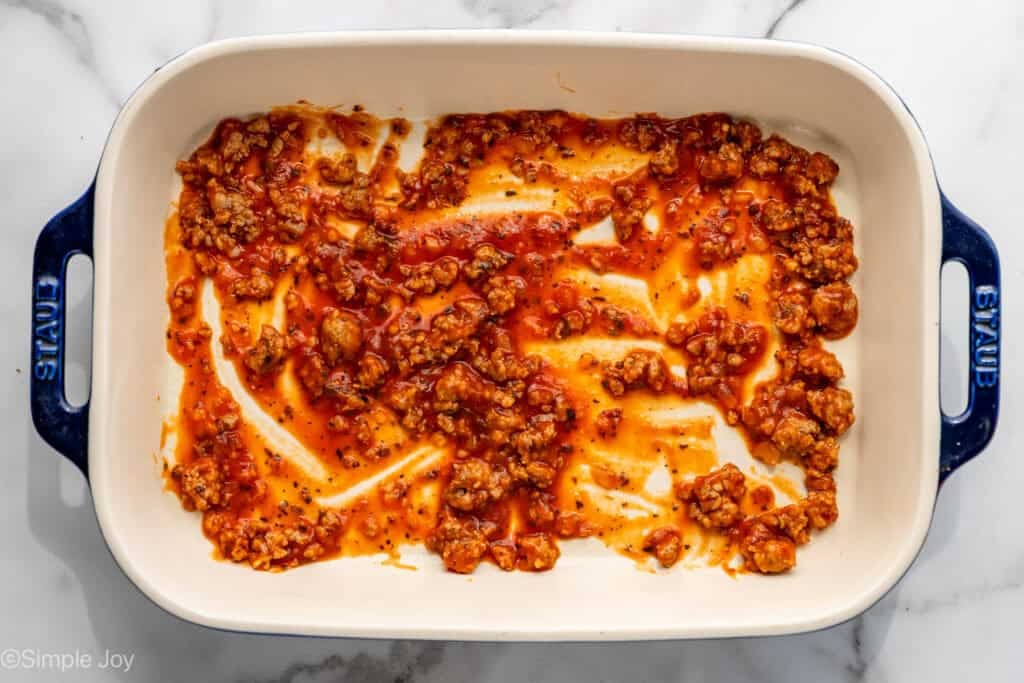 overhead of a baking dish with meat sauce in the bottom