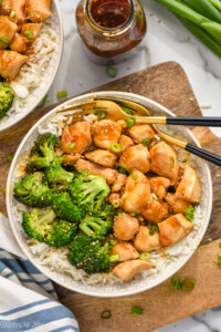 Overhead photo of teriyaki chicken bowl served with broccoli over rice and two forks