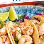 Pinterest graphic for Bang Bang Shrimp Tacos recipe. Text says, "the best Bang Bang Shrimp Tacos simplejoy.com." Image is close up photo of Bang Bang Shrimp Tacos garnished with lime wedges.